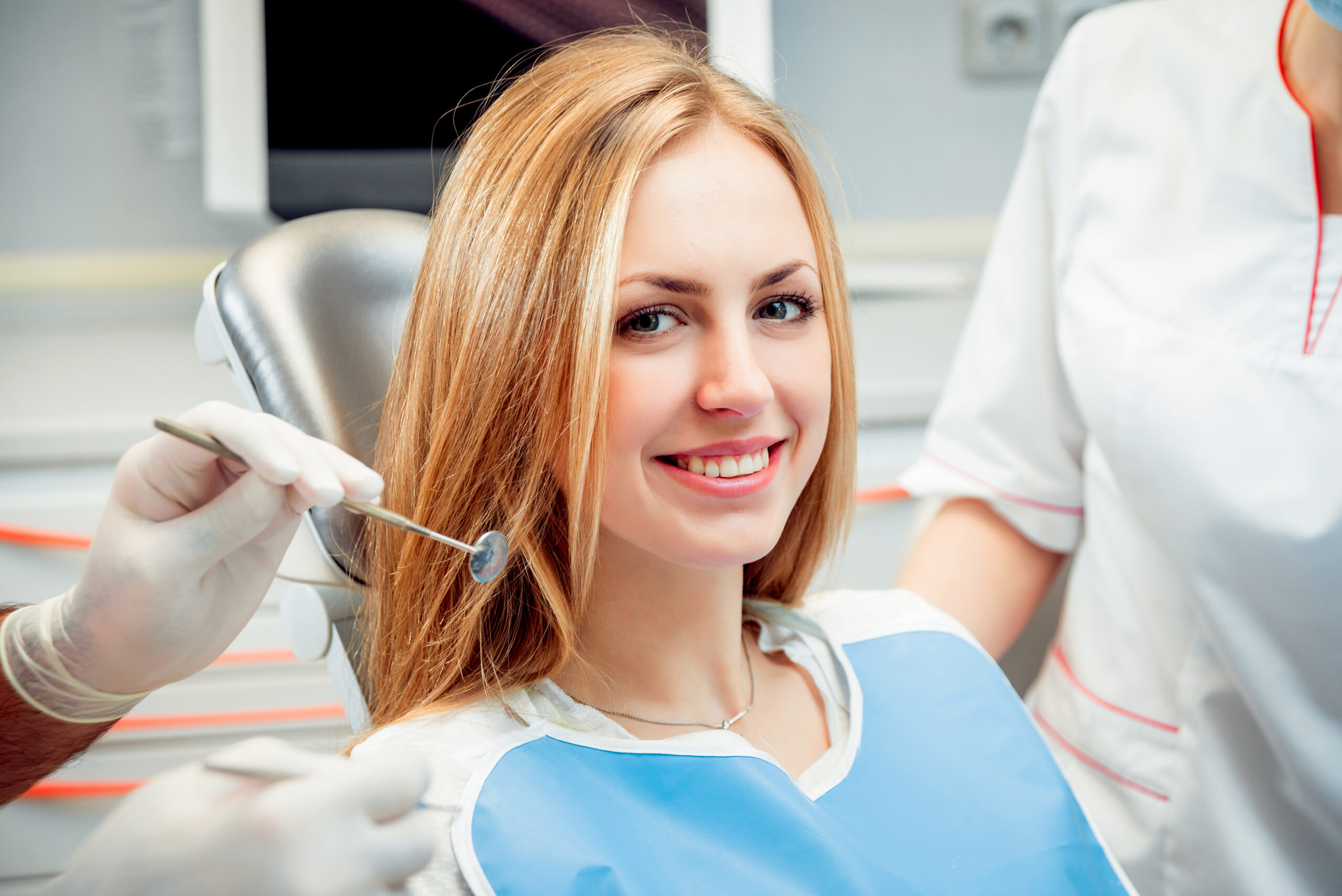 Young smiled woman at the dental office. Medical equipment