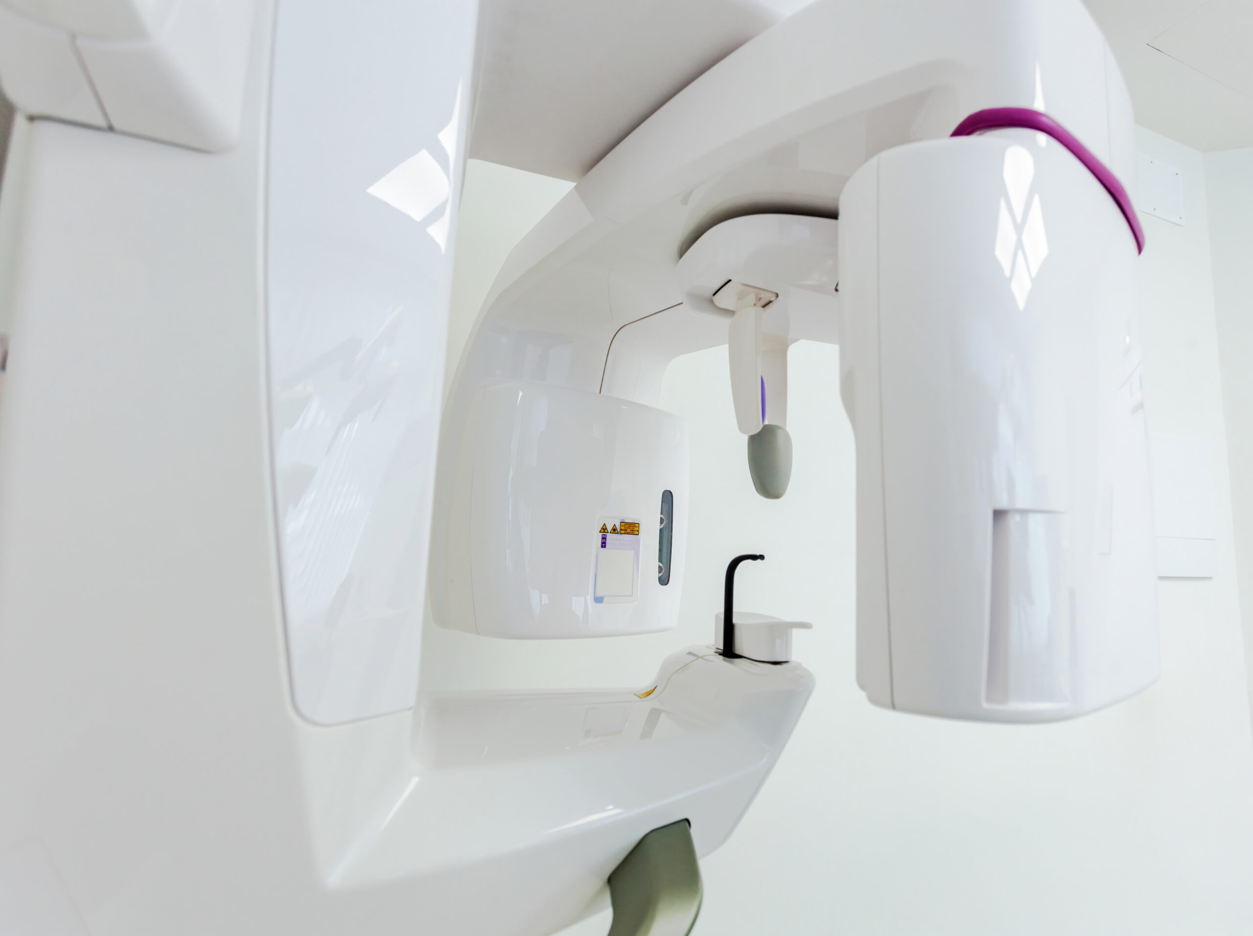 Close up view of a cbct scanner positioned in a bright, sterile dental clinic, prepared for an upcoming dental scan