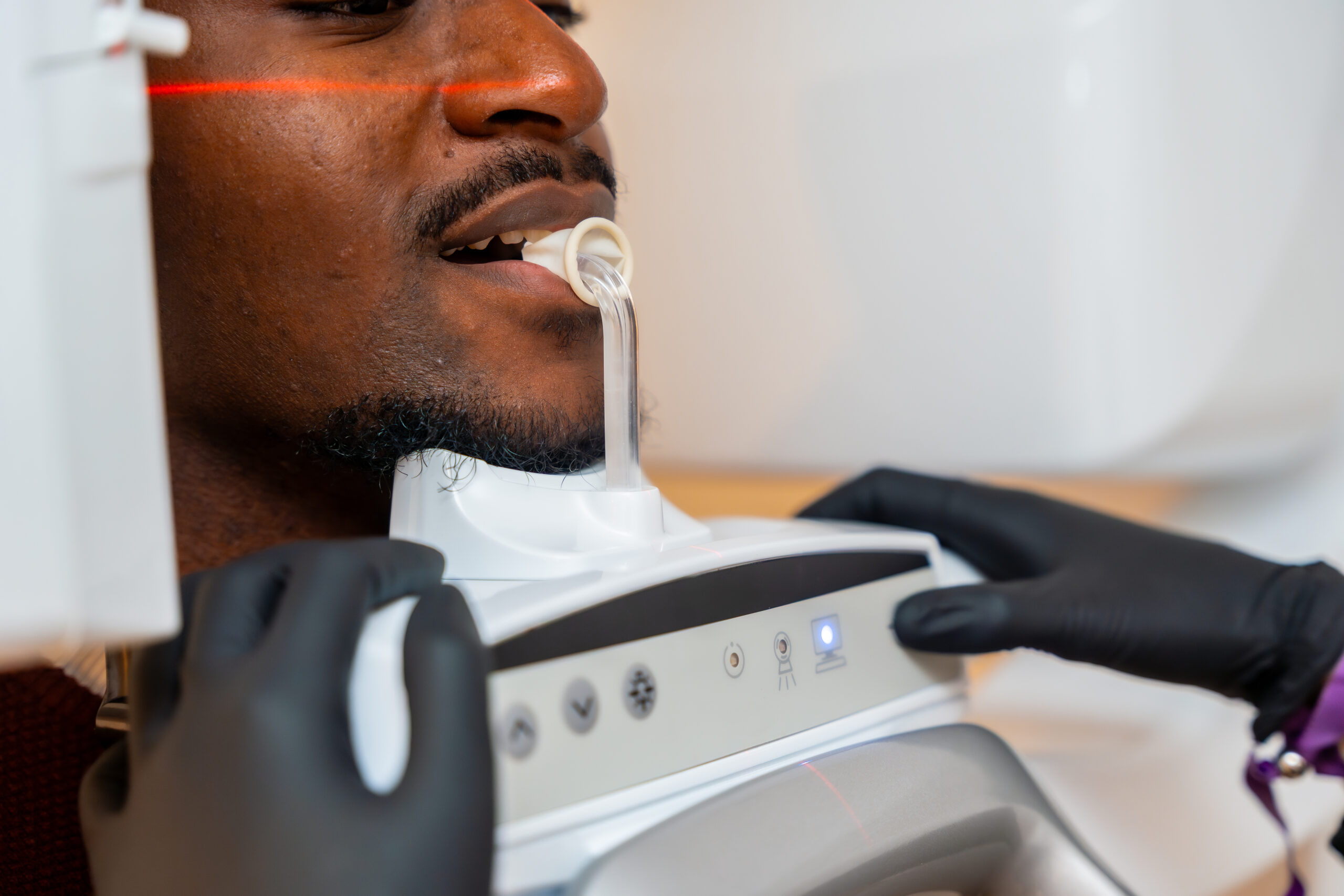 Dentist performing a dental x ray scan on a patient inside a modern dental clinic, ensuring accurate diagnosis and optimal oral health